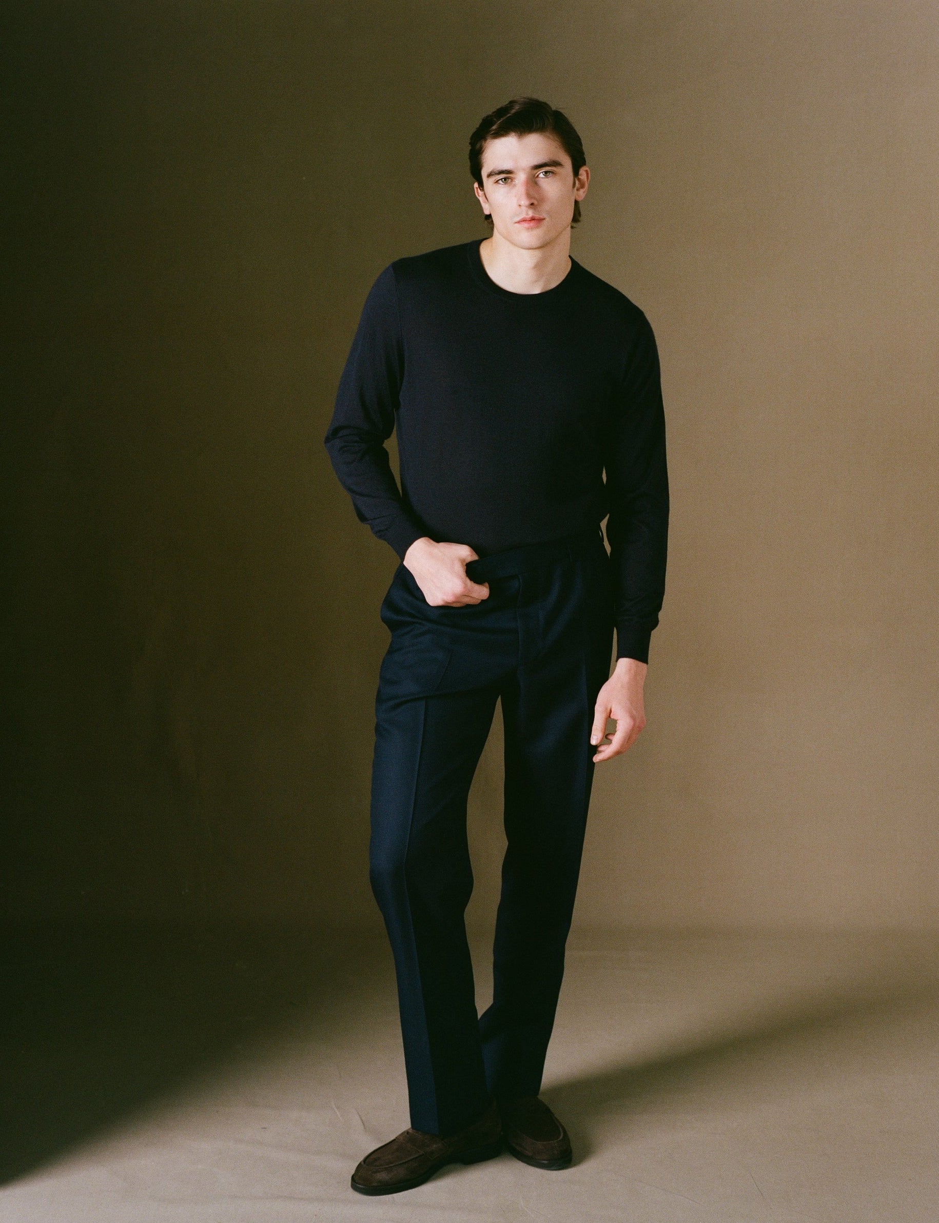 Navy cotton chino trousers on model