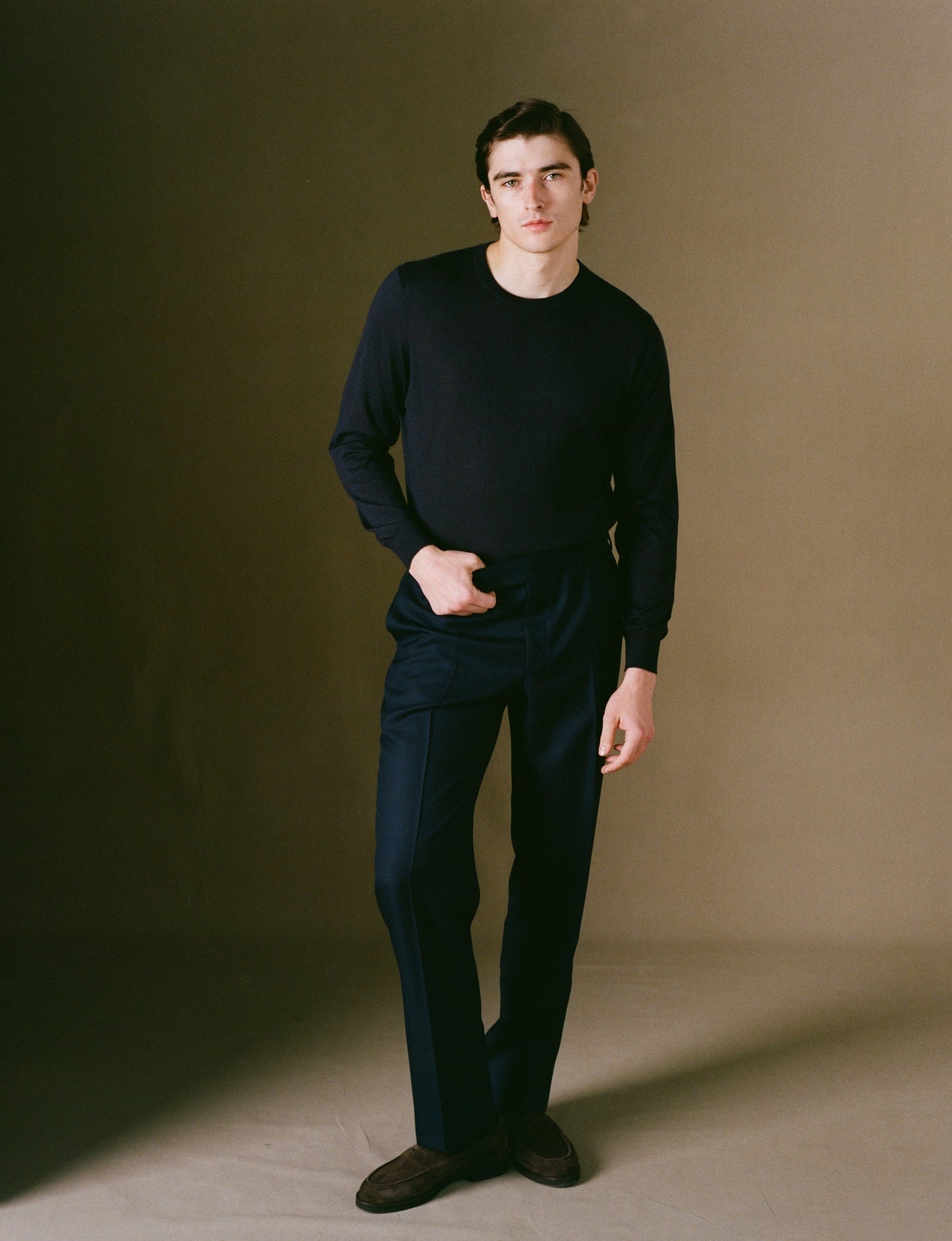 Navy cotton chino trousers on model