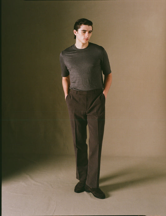 Dark brown wide leg trousers on model 