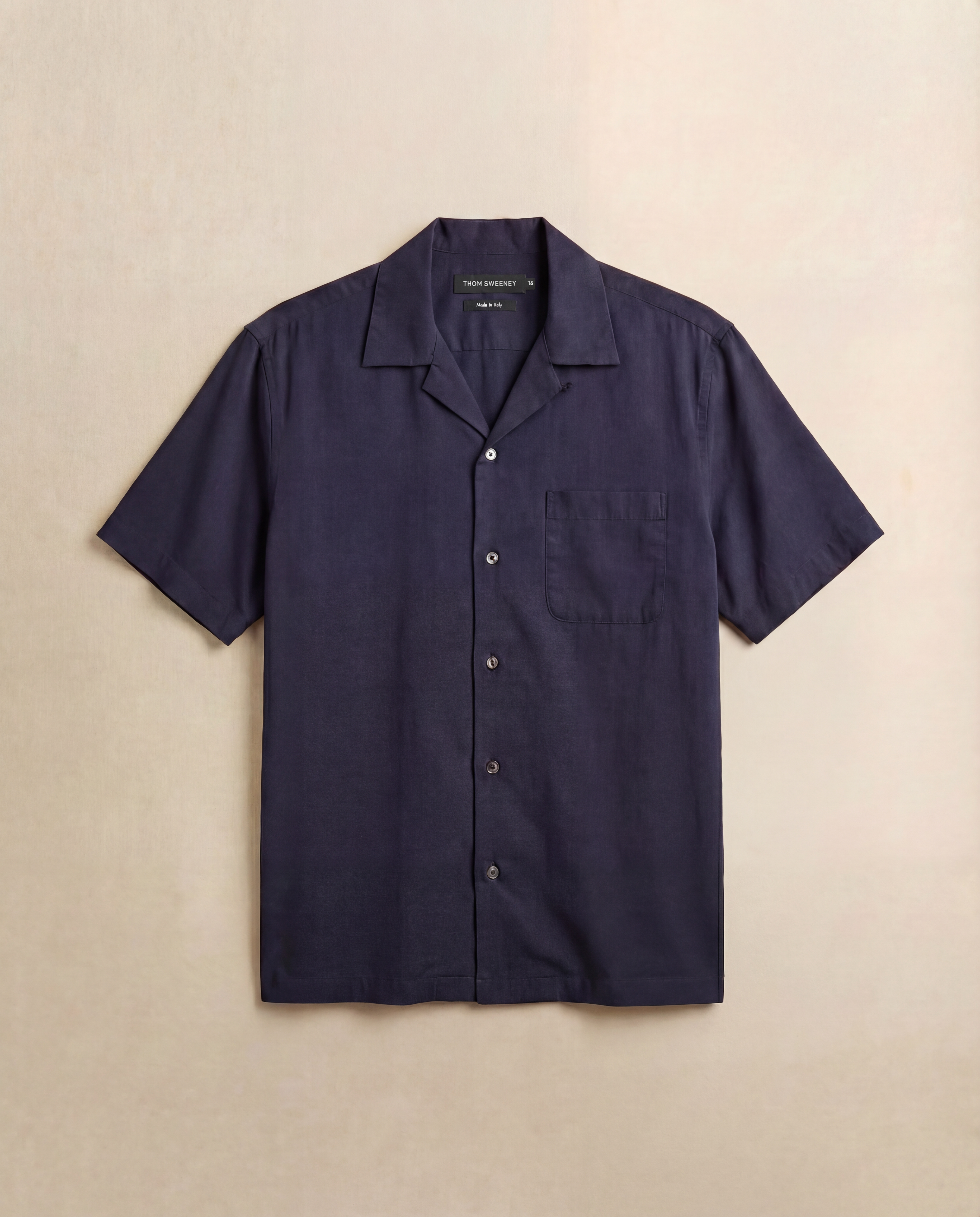 Navy short-sleeve shirt on a beige background