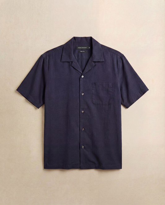 Navy short-sleeve shirt on a beige background