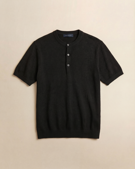 Black coloured short-sleeve sweater with button details on a beige background