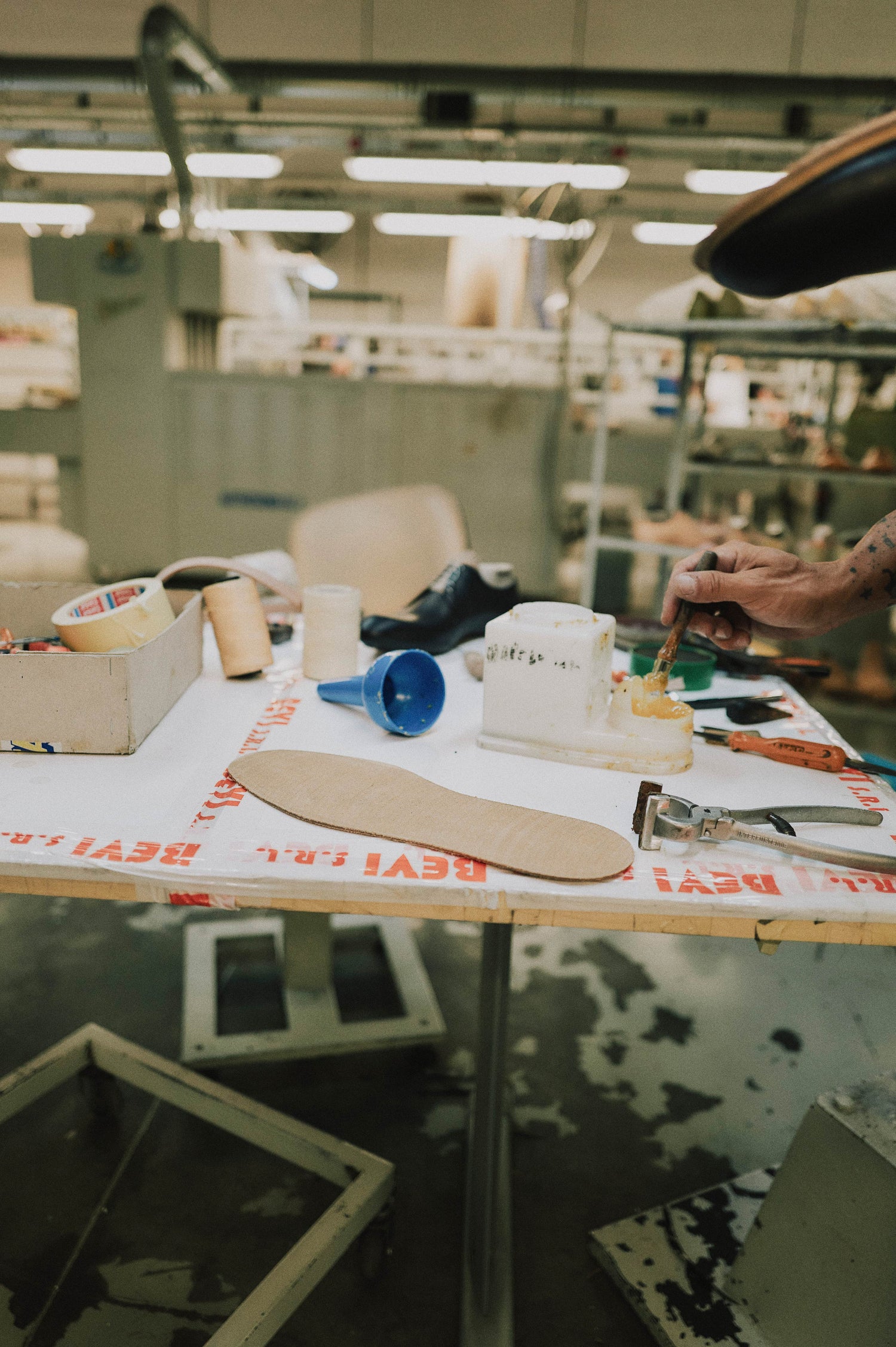 Sole Being Painted With Adhesive